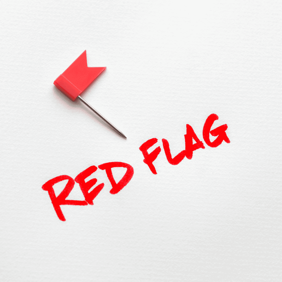 Red flag icon with the words ‘RED FLAG’ on a peach background—visual cue for caution/warning signs.