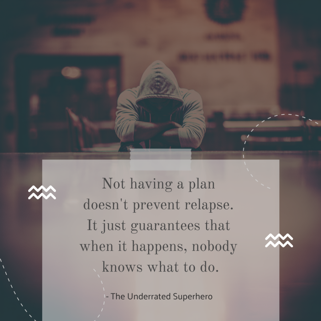 Person in a hoodie sitting with head down at a table representing the emotional weight of addiction recovery with quote about planning for managing relapse and the importance of having a relapse plan